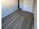 This bedroom has plank flooring and a closet with sliding doors for storage at 521 10Th St, Fort Lupton, CO 80621