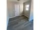 Entryway featuring gray wood-look floors, a front door and a side window at 521 10Th St, Fort Lupton, CO 80621