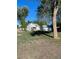 A white home with a detached garage and mature trees in the yard at 521 10Th St, Fort Lupton, CO 80621