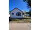 Charming single-story home with white siding, a blue trim, and a detached garage at 521 10Th St, Fort Lupton, CO 80621