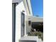 Close up of a home's front door with security door and awning with address above at 521 10Th St, Fort Lupton, CO 80621
