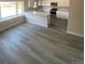 Open-concept kitchen featuring gray wood floors, white cabinetry and a center island at 521 10Th St, Fort Lupton, CO 80621