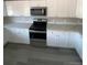 Close up of kitchen area with white cabinets, gray countertops, and stainless steel appliances at 521 10Th St, Fort Lupton, CO 80621