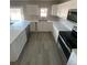 Bright kitchen featuring a U-shaped layout, white cabinetry and stainless-steel appliances at 521 10Th St, Fort Lupton, CO 80621
