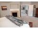 Main bedroom with fireplace and access to upper level at 6588 S Sheridan Loop, Littleton, CO 80123