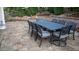 Outdoor dining set and fire pit with beautiful pavers create a cozy outdoor living space at 6588 S Sheridan Loop, Littleton, CO 80123