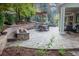 Outdoor patio featuring a fire pit, hot tub, dining set, and lovely landscaping at 6588 S Sheridan Loop, Littleton, CO 80123