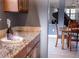 Elegant wet bar with granite countertop, wine storage, and view of dining area at 6588 S Sheridan Loop, Littleton, CO 80123