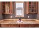 Built-in wet bar with granite countertop and glass cabinets at 6588 S Sheridan Loop, Littleton, CO 80123