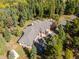 Aerial view of a stunning home nestled among lush greenery and mature trees at 26886 Evergreen Springs Rd, Evergreen, CO 80439