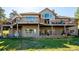 Large backyard featuring a two-level deck with great windows, a walkout basement and stone accents at 26886 Evergreen Springs Rd, Evergreen, CO 80439