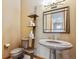 Unique powder room with pedestal sink, decorative shelving, and modern fixtures at 26886 Evergreen Springs Rd, Evergreen, CO 80439