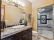 Modern bathroom with granite countertop, glass-enclosed shower, and neutral colors at 26886 Evergreen Springs Rd, Evergreen, CO 80439