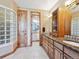 Elegant bathroom featuring double vanities and abundant natural light at 26886 Evergreen Springs Rd, Evergreen, CO 80439