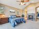 Comfortable bedroom with fireplace and plenty of natural light at 26886 Evergreen Springs Rd, Evergreen, CO 80439