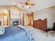 Spacious bedroom with a cozy fireplace, carpeted floors, natural light, and a view to the Ensuite bathroom at 26886 Evergreen Springs Rd, Evergreen, CO 80439