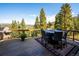 Outdoor deck boasts expansive views and seating for six at 26886 Evergreen Springs Rd, Evergreen, CO 80439