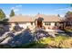 Charming home showcasing a three-car garage and classic architecture and stone accents at 26886 Evergreen Springs Rd, Evergreen, CO 80439