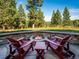 Inviting stone patio featuring a cozy fire pit and comfortable seating, perfect for outdoor relaxation and entertaining at 26886 Evergreen Springs Rd, Evergreen, CO 80439