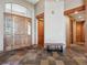 Inviting foyer boasting tile flooring, wooden accents, and plenty of natural light at 26886 Evergreen Springs Rd, Evergreen, CO 80439