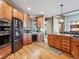 Stylish kitchen with stainless steel appliances, custom cabinets, and hardwood floors at 26886 Evergreen Springs Rd, Evergreen, CO 80439