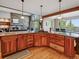 Open kitchen with wood floors, fireplace, granite counters and pendant lighting at 26886 Evergreen Springs Rd, Evergreen, CO 80439