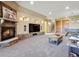 Cozy living room with stone fireplace, built-in shelving, and a large mounted television at 26886 Evergreen Springs Rd, Evergreen, CO 80439