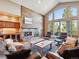 Elegant living room with a cozy fireplace and expansive windows for abundant natural light at 26886 Evergreen Springs Rd, Evergreen, CO 80439