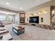 Spacious living room featuring a stone fireplace, built-in shelving and a mounted tv at 26886 Evergreen Springs Rd, Evergreen, CO 80439