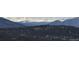 A tranquil view of the mountains covered in trees from a distance at 26886 Evergreen Springs Rd, Evergreen, CO 80439