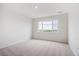 Spacious bedroom with a large window and neutral carpeting at 487 Interlocken Blvd # 304, Broomfield, CO 80021