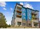Modern apartment building with blue accents and brick detailing at 487 Interlocken Blvd # 304, Broomfield, CO 80021