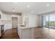 Modern kitchen with island, white cabinets, stainless steel appliances, and hardwood floors at 487 Interlocken Blvd # 304, Broomfield, CO 80021