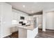 Modern kitchen with white cabinets, quartz countertops, and stainless steel appliances at 487 Interlocken Blvd # 304, Broomfield, CO 80021