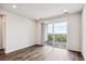 Living room with balcony access and hardwood floors at 487 Interlocken Blvd # 304, Broomfield, CO 80021