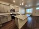 Open concept kitchen with island, granite countertops, and stainless steel appliances at 7008 Kali Ct, Frederick, CO 80530