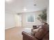 Cozy basement featuring carpet, egress window, neutral paint, and comfortable seating area at 1026 Deer Clover Way, Castle Pines, CO 80108