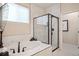Bathroom featuring modern soaking tub, black fixtures, and black framed glass shower at 1026 Deer Clover Way, Castle Pines, CO 80108