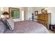 Bedroom with hardwood floors, a wrought iron bed frame, and natural light from the window at 1026 Deer Clover Way, Castle Pines, CO 80108