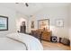 Bright bedroom with hardwood floors, artwork, and vaulted ceilings at 1026 Deer Clover Way, Castle Pines, CO 80108