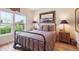Bedroom featuring a wrought iron bed frame, hardwood floors, and natural light at 1026 Deer Clover Way, Castle Pines, CO 80108