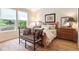 Bedroom with wooden bed frame, hardwood floors, and lots of natural light at 1026 Deer Clover Way, Castle Pines, CO 80108