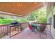 Covered deck offers an outdoor dining area with views of the well manicured backyard at 1026 Deer Clover Way, Castle Pines, CO 80108
