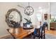 Well-lit dining area with a wooden table, comfortable seating, and stylish decorative elements at 1026 Deer Clover Way, Castle Pines, CO 80108