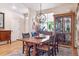Elegant dining room with hardwood floors, a rustic wooden table, and stylish light fixture at 1026 Deer Clover Way, Castle Pines, CO 80108