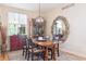 Charming dining area featuring a wooden table, decorative mirror, and ample natural light at 1026 Deer Clover Way, Castle Pines, CO 80108