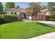 Well-maintained front yard with lush green grass and mature landscaping, creating curb appeal at 1026 Deer Clover Way, Castle Pines, CO 80108