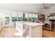 Spacious kitchen island overlooking the living room with stainless steel appliances and a view of the backyard at 1026 Deer Clover Way, Castle Pines, CO 80108
