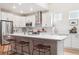 Bright kitchen features stainless steel appliances, center island with bar seating, and modern finishes at 1026 Deer Clover Way, Castle Pines, CO 80108
