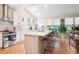 Bright and open kitchen with a large island, white countertops, and stainless steel appliances at 1026 Deer Clover Way, Castle Pines, CO 80108